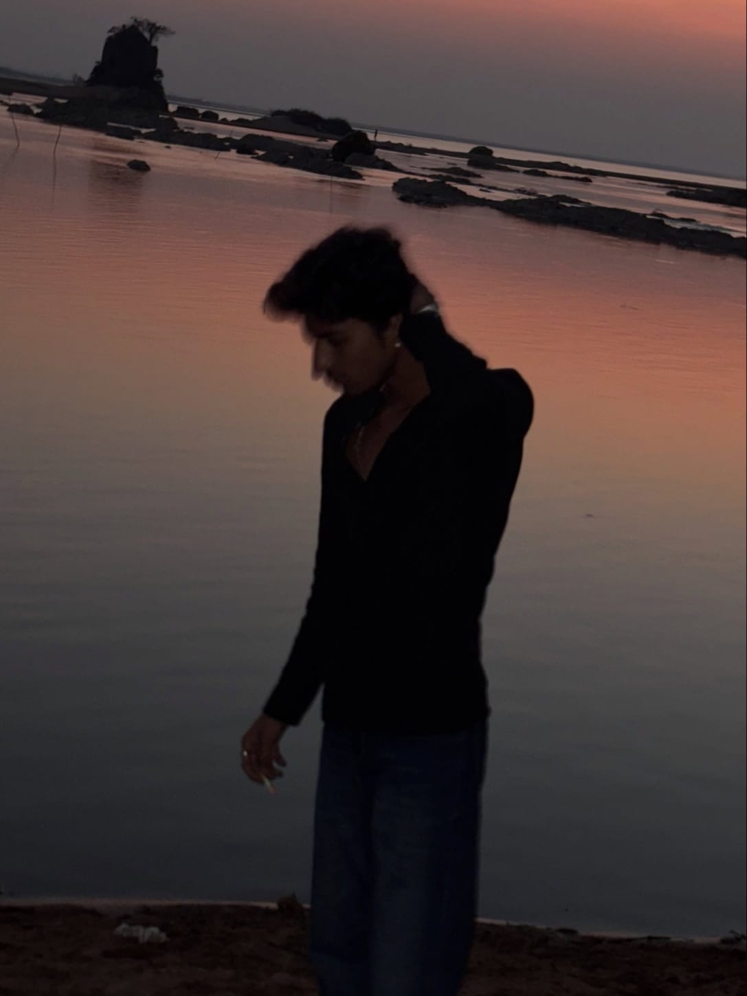 Haidar by the water at sunset